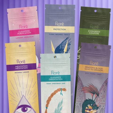 Six different packages of incense sticks lay in two rows against a purple background. The back row includes Cleansing, Protection and Evergreen, and the front row includes Meditation, Guidance, and Dragon’s Blood.