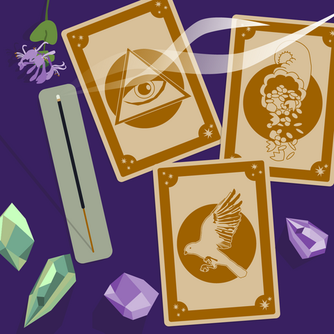 Overhead illustrated view of three unique tarot cards featuring the third eye in a pyramid, a crow, and a cornucopia. The cards are laying next to crystals, a flower, and a burning incense stick against a dark purple background.