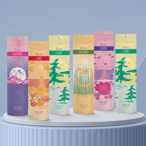 Six different packages of incense sticks standing upright against a blue grey background. From left to right the packages include Cleansing, Amber, Cypress, Sweetgrass, Lavender and Cedar.