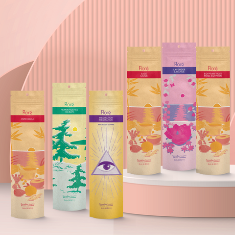 Six different packages of incense sticks standing upright against a pale peach background. From left to right the packages include Patchouli, Frankincense, Meditation, Sage, Lavender, and Egyptian Musk.