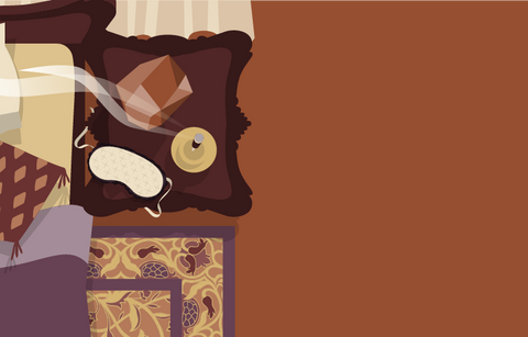 Overhead illustrated view of a lusciously adorned bedroom showing the corner of a cozy bed with throw pillows next to a night stand containing a salt rock lamp, sleep mask, and burning stick of incense. An ornate rug is visible next to the bed. 