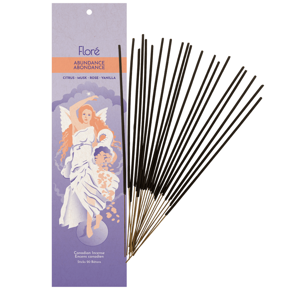 Image of 1 of package Flore Canadian Incense Abundance fragrance, featuring an angel woman holding a cornucopia below a north star. There are 20 incense sticks splayed beside it as every package contains 20 incense sticks. Scent notes displayed are citrus, musk, rose, vanilla.
