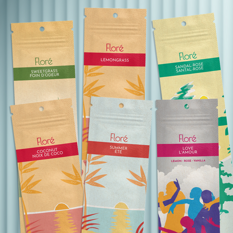 Six different packages of incense sticks lay in two rows against a grey background. The back row includes Sweetgrass, Lemongrass and Sandal-Rose, and the front row includes Coconut, Summer and Love. 