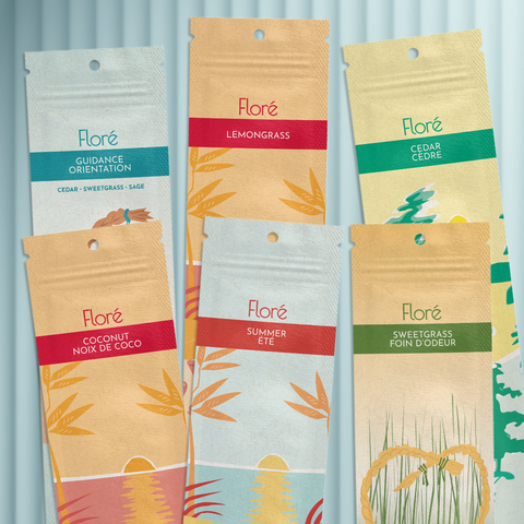 Six different packages of incense sticks lay in two rows against a pale blue background. The back row includes Guidance, Lemongrass and Cedar, and the front row includes Coconut, Summer and Sweetgrass.