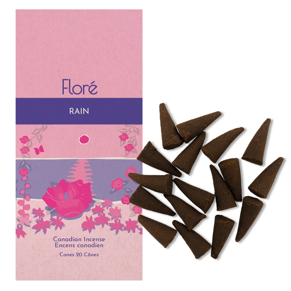 Image of Flore Canadian Incense Rain package, featuring a prominent rose flower on a beach with smaller flowers around it.There are 20 cones sticks splayed beside it as every package contains 20 incense cones. 