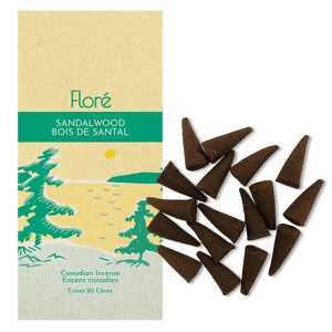 
            
                Load image into Gallery viewer, Image of Flore Canadian Incense Sandalwood package, featuring green pine trees on a golden lake with a yellow sun. There are 20 incense cones splayed beside it as every package contains 20 incense cones. 
            
        
