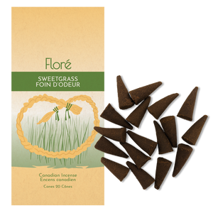 
            
                Load image into Gallery viewer, Image of Flore Canadian Incense Sweetgrass package, featuring a braid of sweetgrass in the green grass. There are 20 incense cones splayed beside it as every package contains 20 incense cones.
            
        