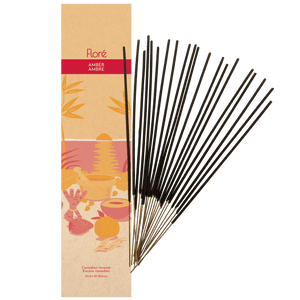 Image of Flore Canadian Incense Amber package, featuring a strawberry, orange, cinnamon stick, mortar and pestle on a warm beach. There are 20 incense sticks splayed beside it as every package contains 20 incense sticks