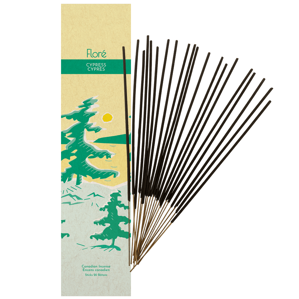 
            
                Load image into Gallery viewer, Image of Flore Canadian Incense Cypress package, featuring green pine trees on a golden lake with a yellow sun. There are 20 incense sticks splayed beside it as every package contains 20 incense sticks. 
            
        