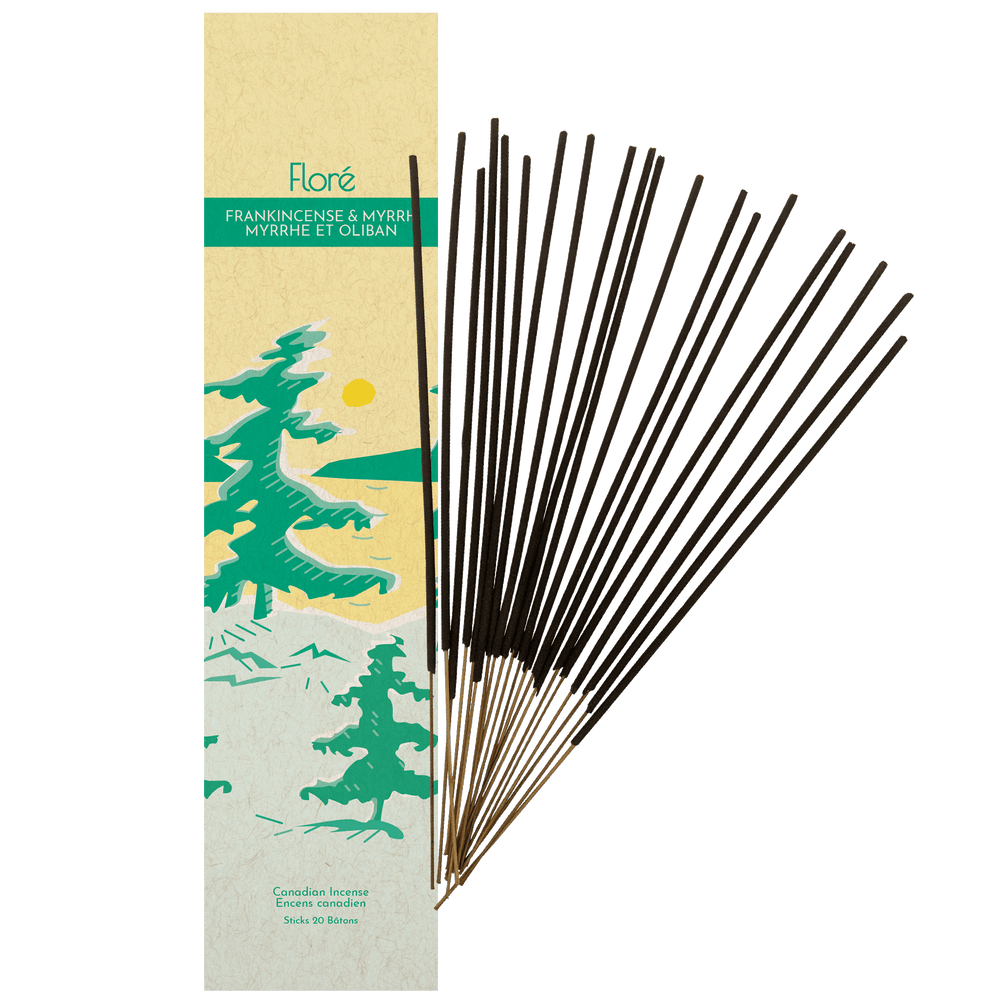 
            
                Load image into Gallery viewer, Image of Flore Canadian Incense Frankincense and Myrrh package, featuring green pine trees on a golden lake with a yellow sun. There are 20 incense sticks splayed beside it as every package contains 20 incense sticks. 
            
        