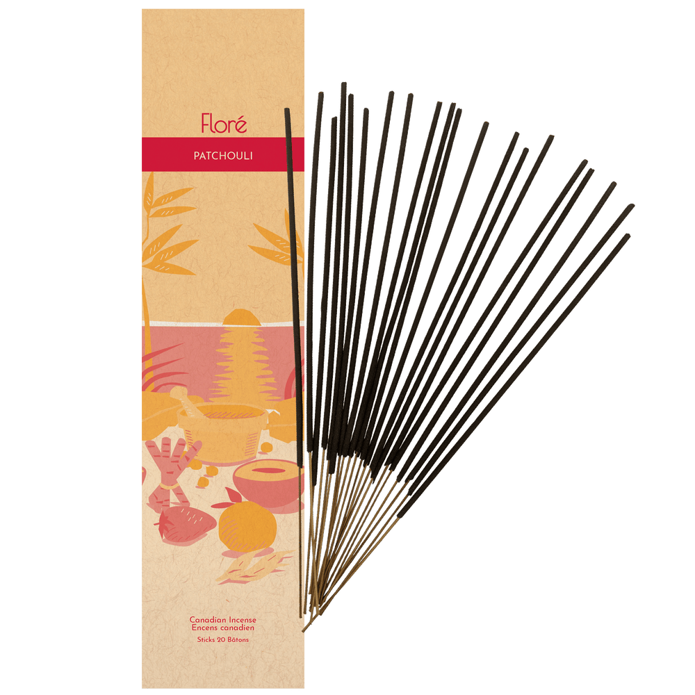 Image of Flore Canadian Incense Patchouli package, featuring a strawberry, orange, cinnamon stick, mortar and pestle on a warm beach. There are 20 incense sticks splayed beside it as every package contains 20 incense sticks