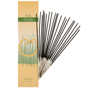 
            
                Load image into Gallery viewer, Image of Flore Canadian Incense Sweetgrass package, featuring a braid of sweetgrass in the green grass. There are 20 incense sticks splayed beside it as every package contains 20 incense sticks.
            
        